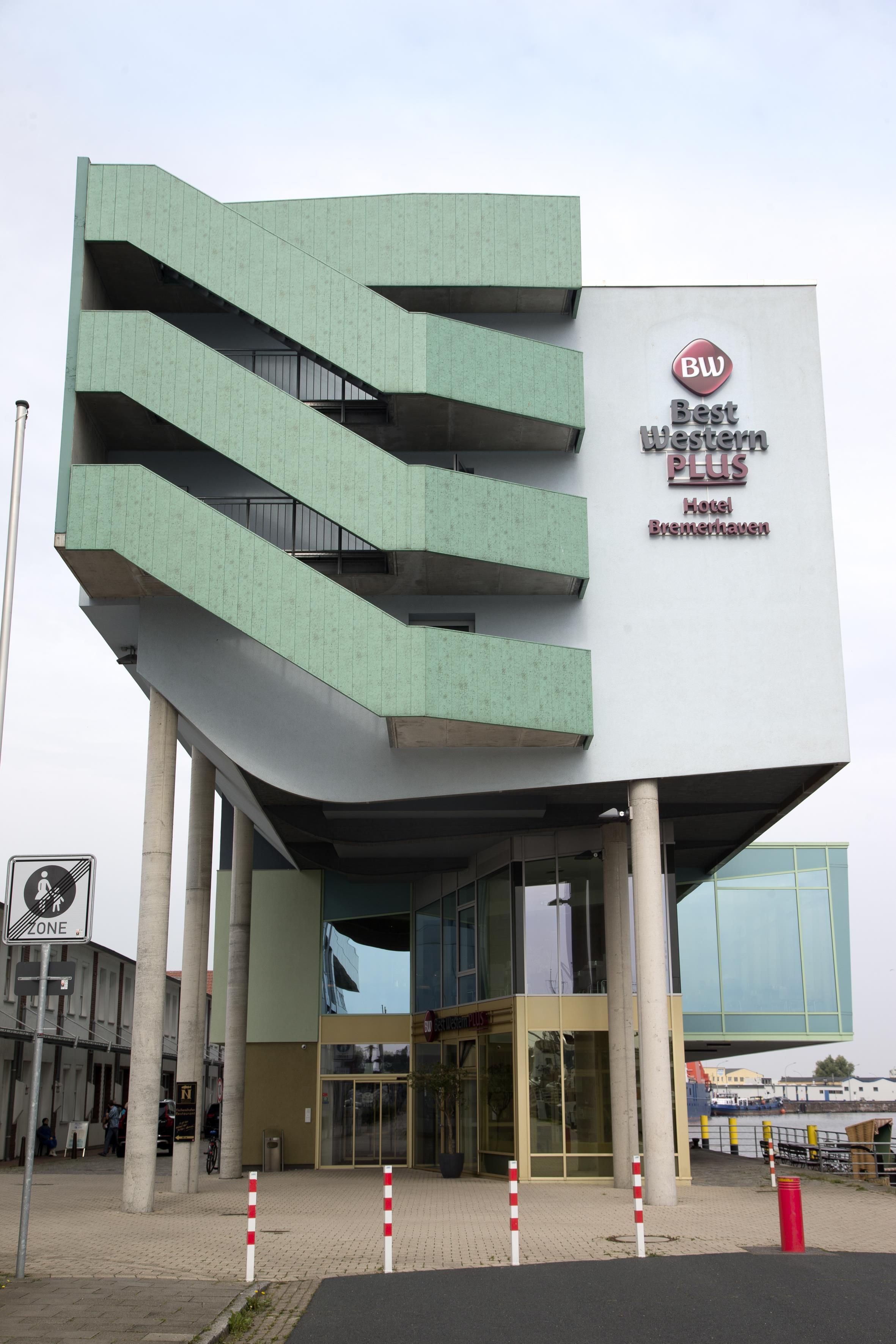 A hotel with a modern design, featuring a prominent 'BW Best Western PLUS Hotel Bremenhaven' sign.