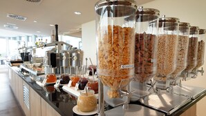 A breakfast buffet with various food options including cereals, jams, and spreads. - Best Western Plus Hotel Bremerhaven (Bremerhaven)