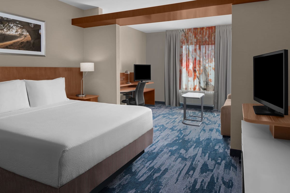 Premium bedding, desk, laptop workspace, iron/ironing board