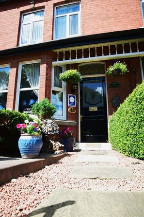A red brick building with a black front door, a sign reading "HEATHFIELD," and a plaque indicating a "CERTIFIED GUEST HOUSE." - Heathfield B&B Guest House (Whitby)