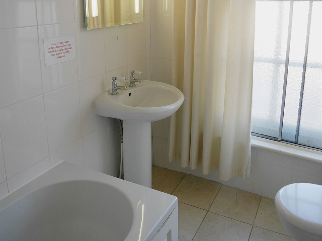 A bathroom with a bathtub, a sink, and a toilet.