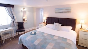 A hotel room with a large bed, bedside tables with lamps, a chair, a desk, and a window with curtains. - The Ellerby Country Inn (Saltburn-by-the-Sea)