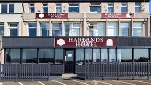 A two-story Harlands Hotel with a prominent sign above the entrance. - Harlands Hotel (Blackpool)