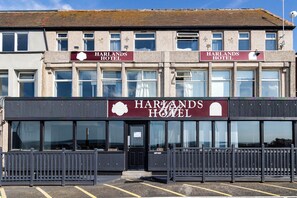 Harlands Hotel features a symmetrical facade with two entrance signs and a black door.