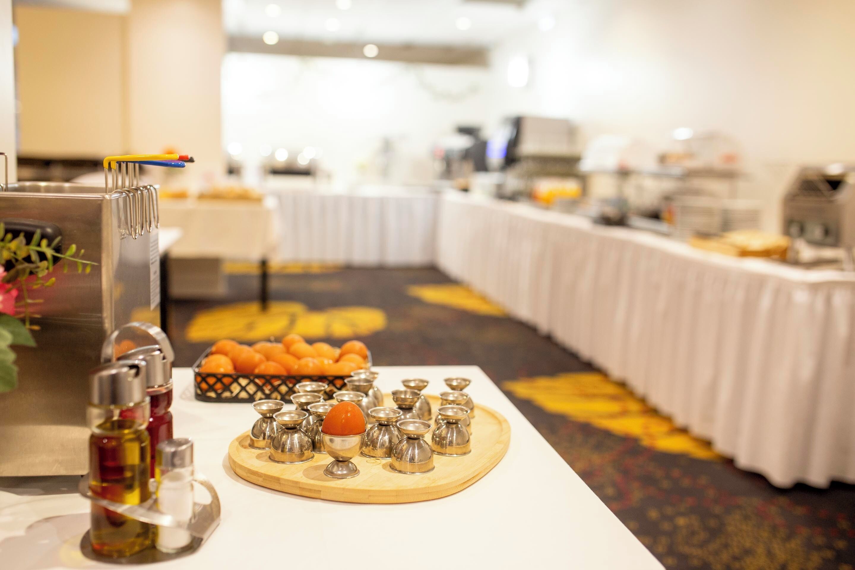A buffet setup with various food items and condiments.