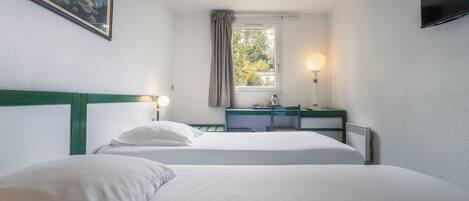A hotel room with two beds, a desk, a chair, a TV, a window with curtains, and a painting on the wall.