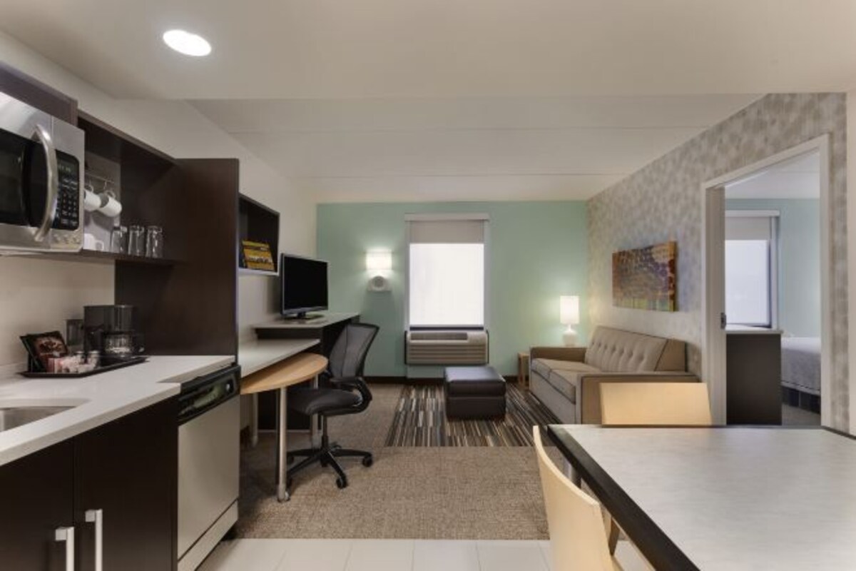 A compact living space with a kitchenette, a dining area, and a seating area.