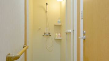 A bathroom with a shower, a toilet, and a sink.
