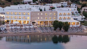 A coastal hotel with multiple floors, outdoor seating, and a pool area. - Patmos Aktis, a Luxury Collection Resort & Spa, Greece (Patmos)