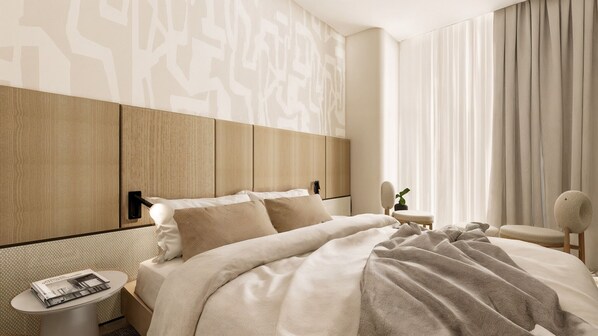 A modern hotel room with a large bed, a bedside table with a magazine, a small side table, and a chair.