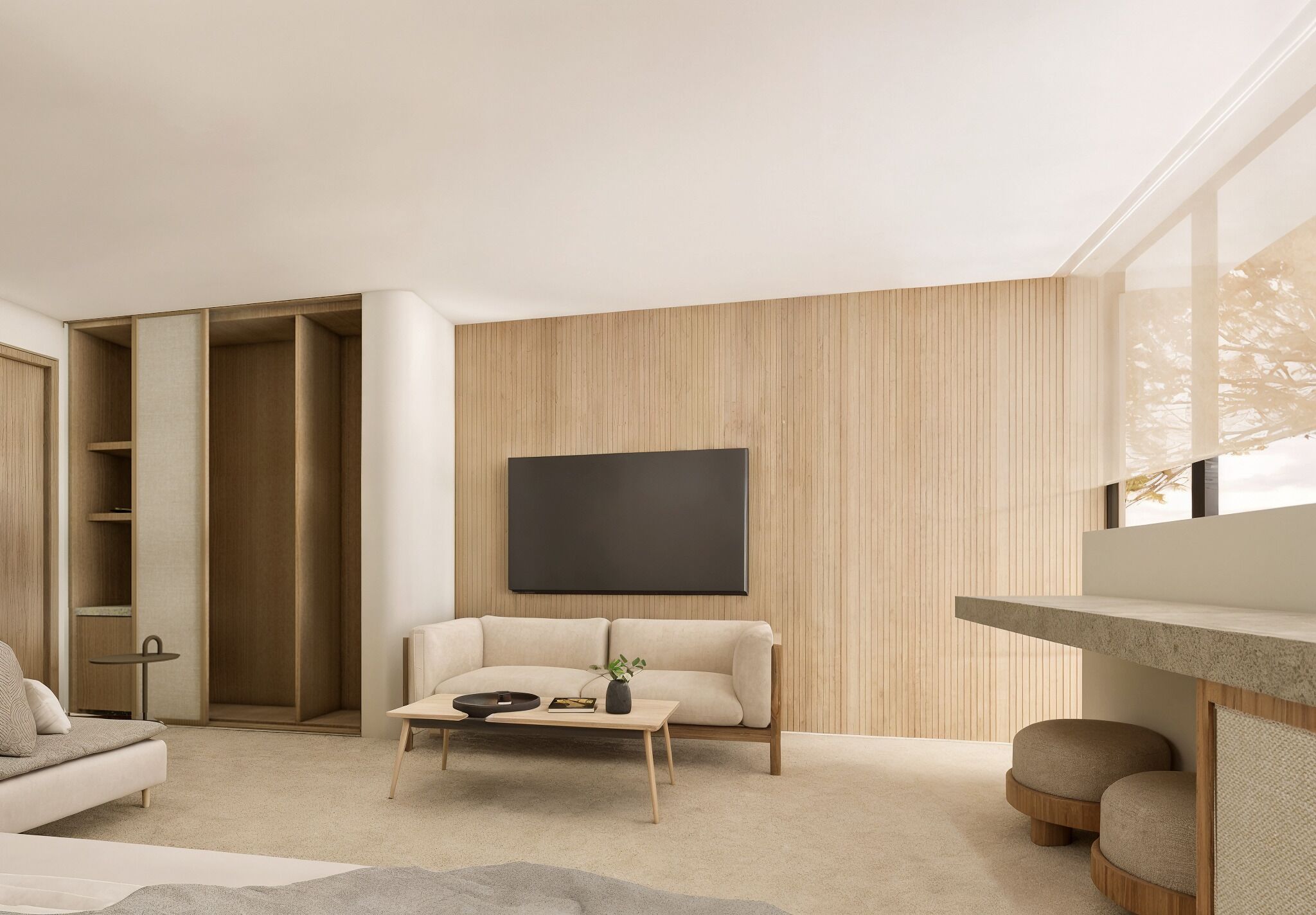 A modern living room with a sofa, coffee table, and a TV mounted on the wall.
