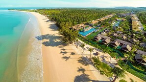 An aerial view of a resort with a beach, pool, and villas. - Graceland Khaolak Beach Resort (Takua Pa)
