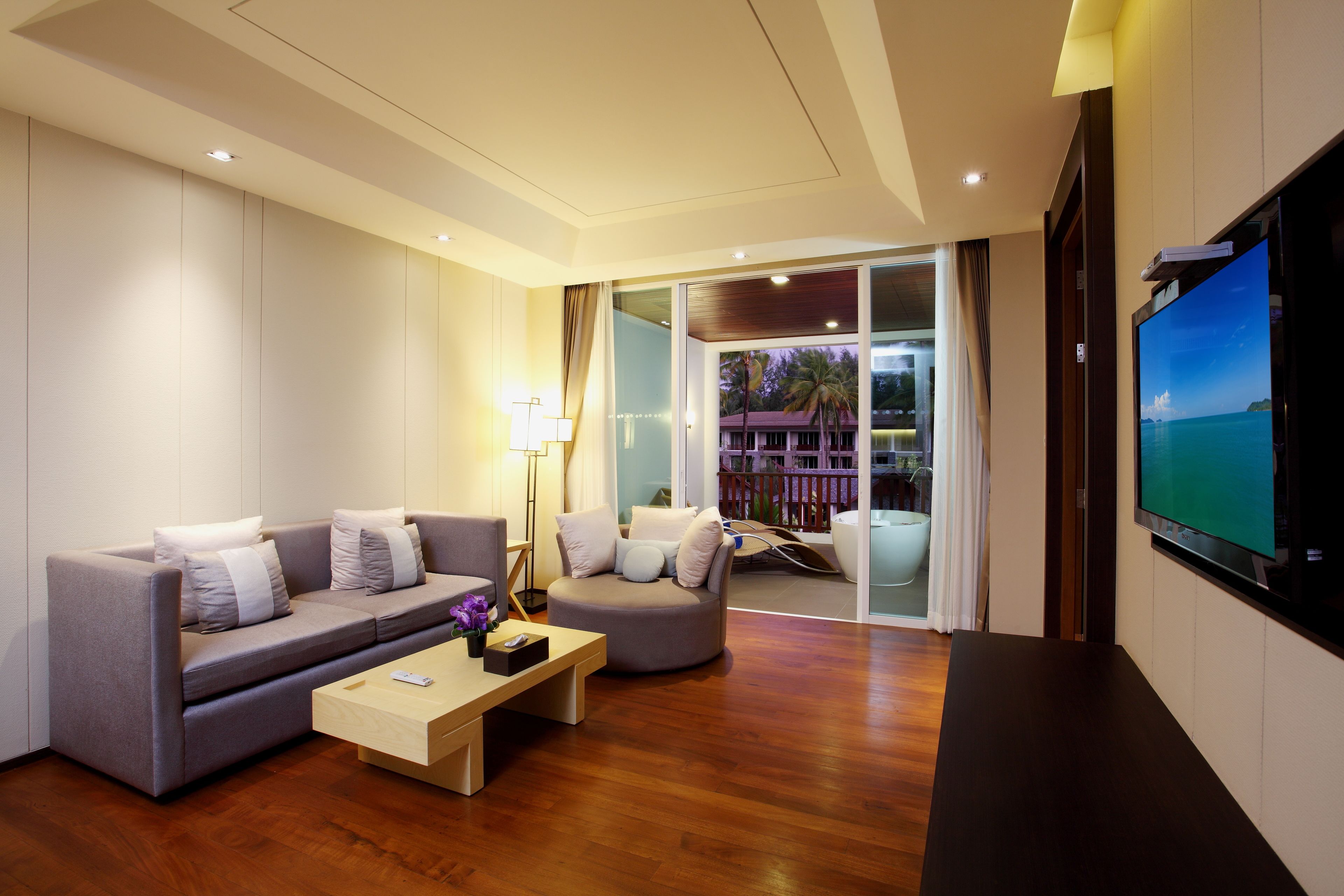 A modern living room with a sofa, a coffee table, and a TV.