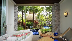 A spa area with a hot tub, lounge chairs, and a pool. - Graceland Khaolak Beach Resort (Takua Pa)