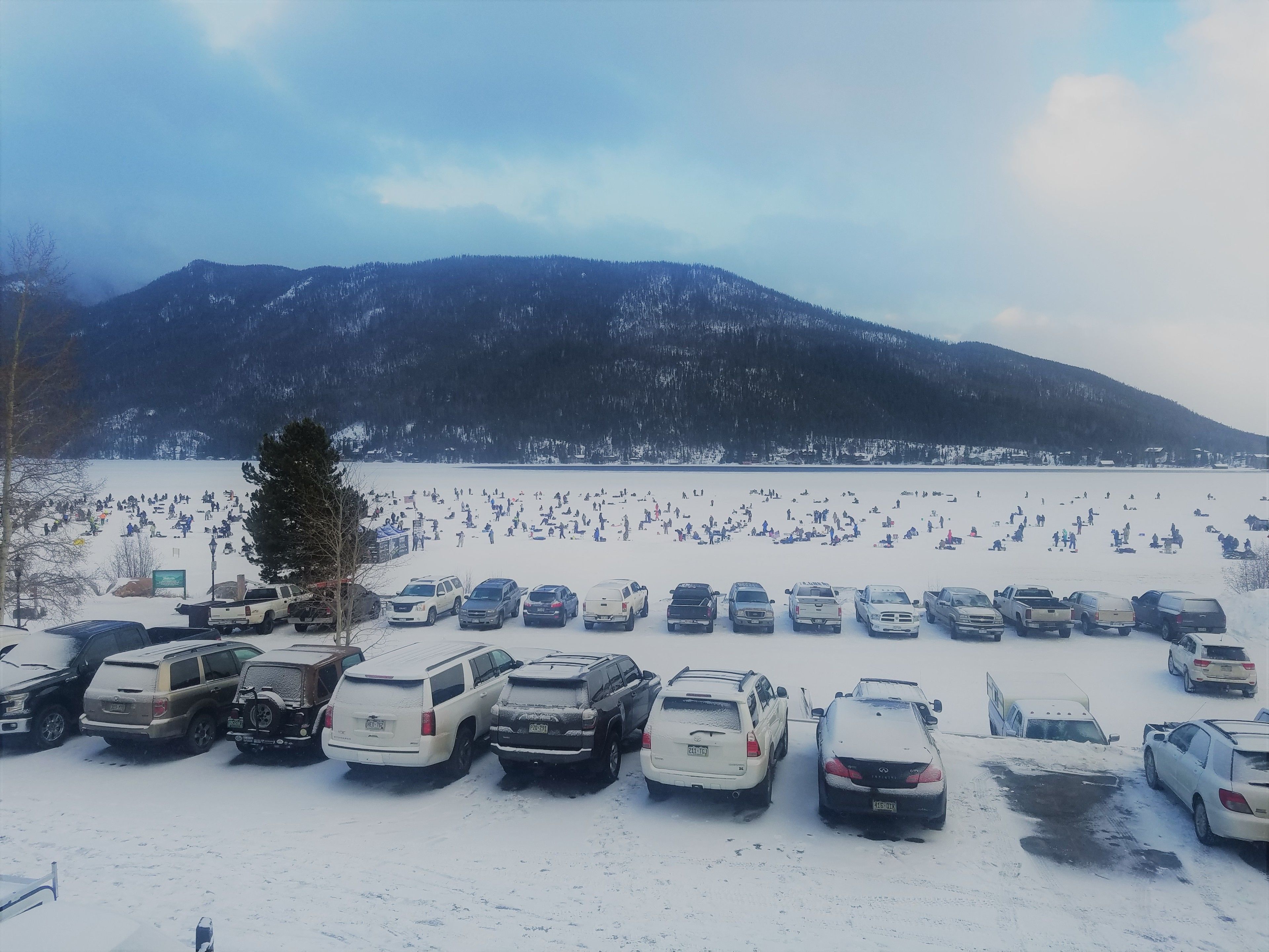 A parking lot with several SUVs and a few cars.