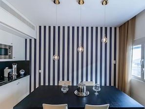 A modern kitchen with a microwave, a coffee machine, and a black countertop. - ibis Lisboa Parque das Naçoes (Lisbon)