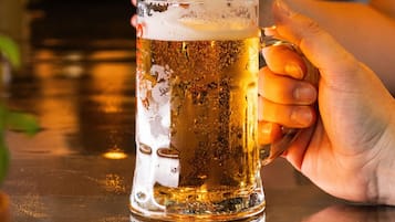 A hand holding a beer mug.