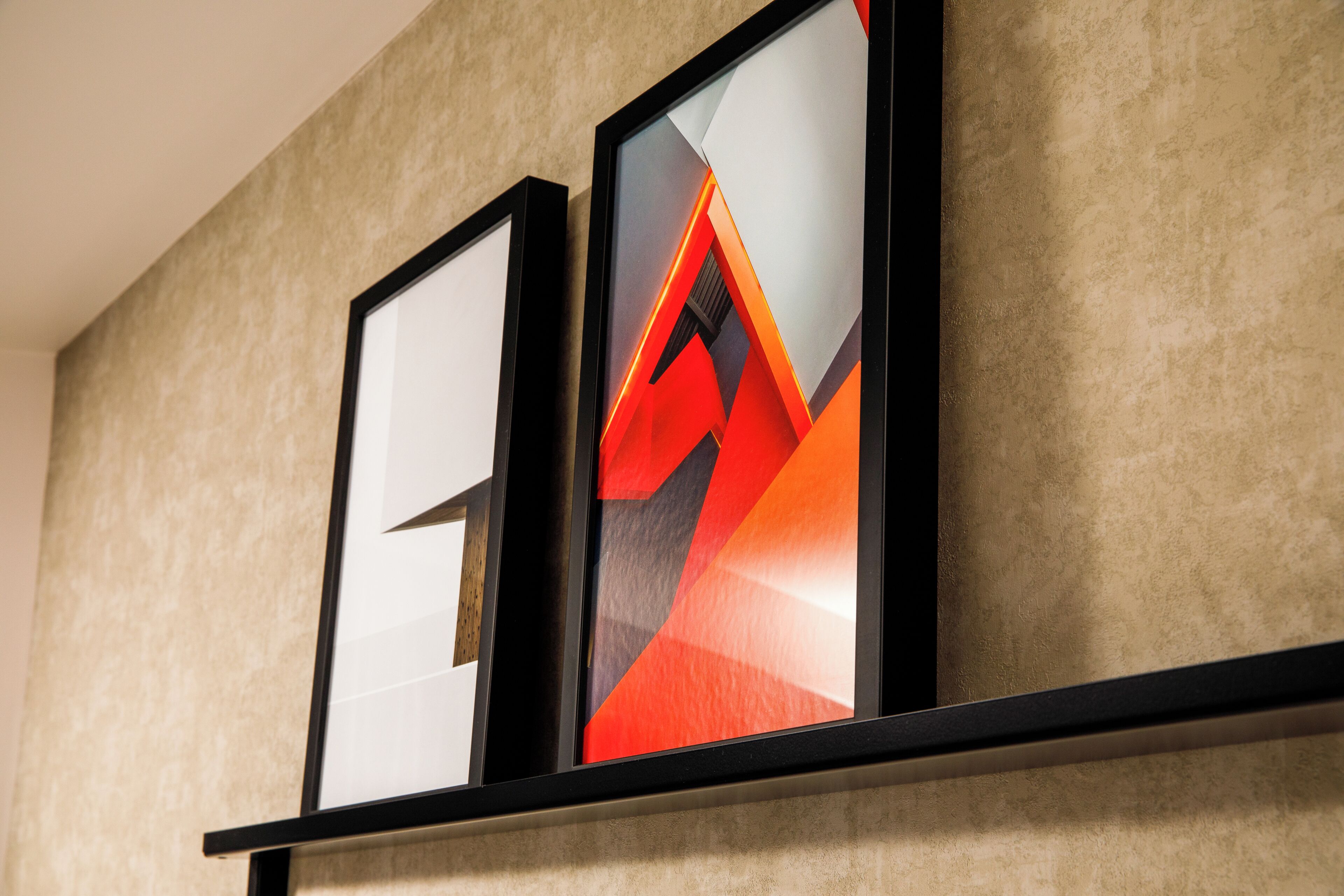 Two framed artworks on a wall.