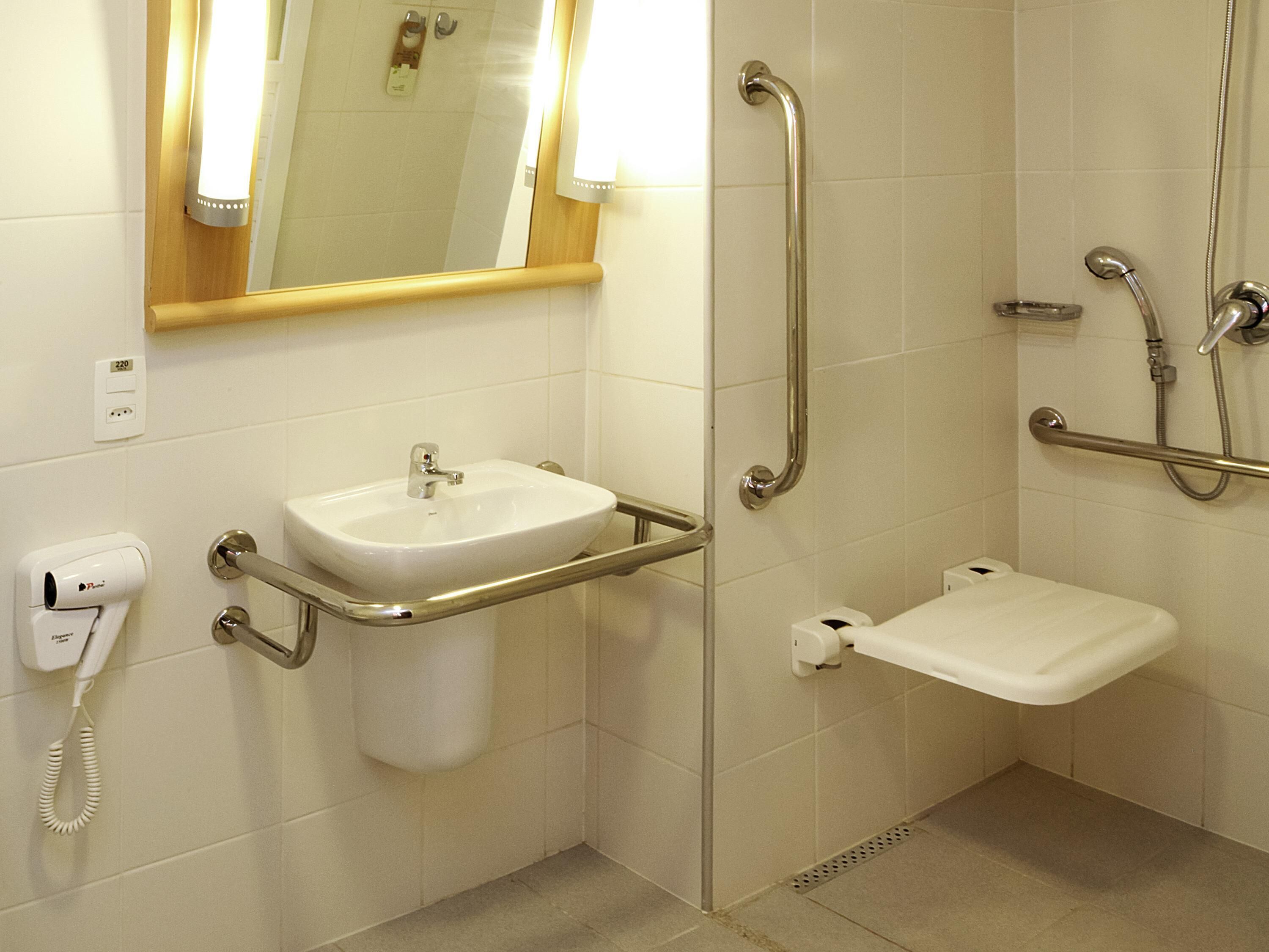 A bathroom with a sink, toilet, and shower.