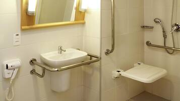 A bathroom with a sink, toilet, and shower.