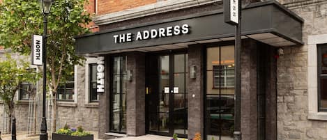 A building with a sign reading "THE ADDRESS" above the entrance.
