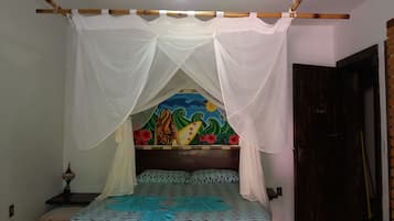 Rest in comfort with a cozy bed featuring a geometric patterned bedspread and a wooden headboard.