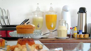 A breakfast buffet with various food items and beverages.