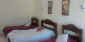 A room with two single beds, each with a wooden headboard and red bedding. - Hotel Portal de Barequeçaba (São Sebastião)