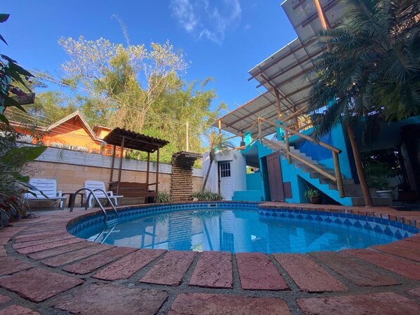 Outdoor pool, a waterfall pool, open 10 AM to 10 PM, pool umbrellas