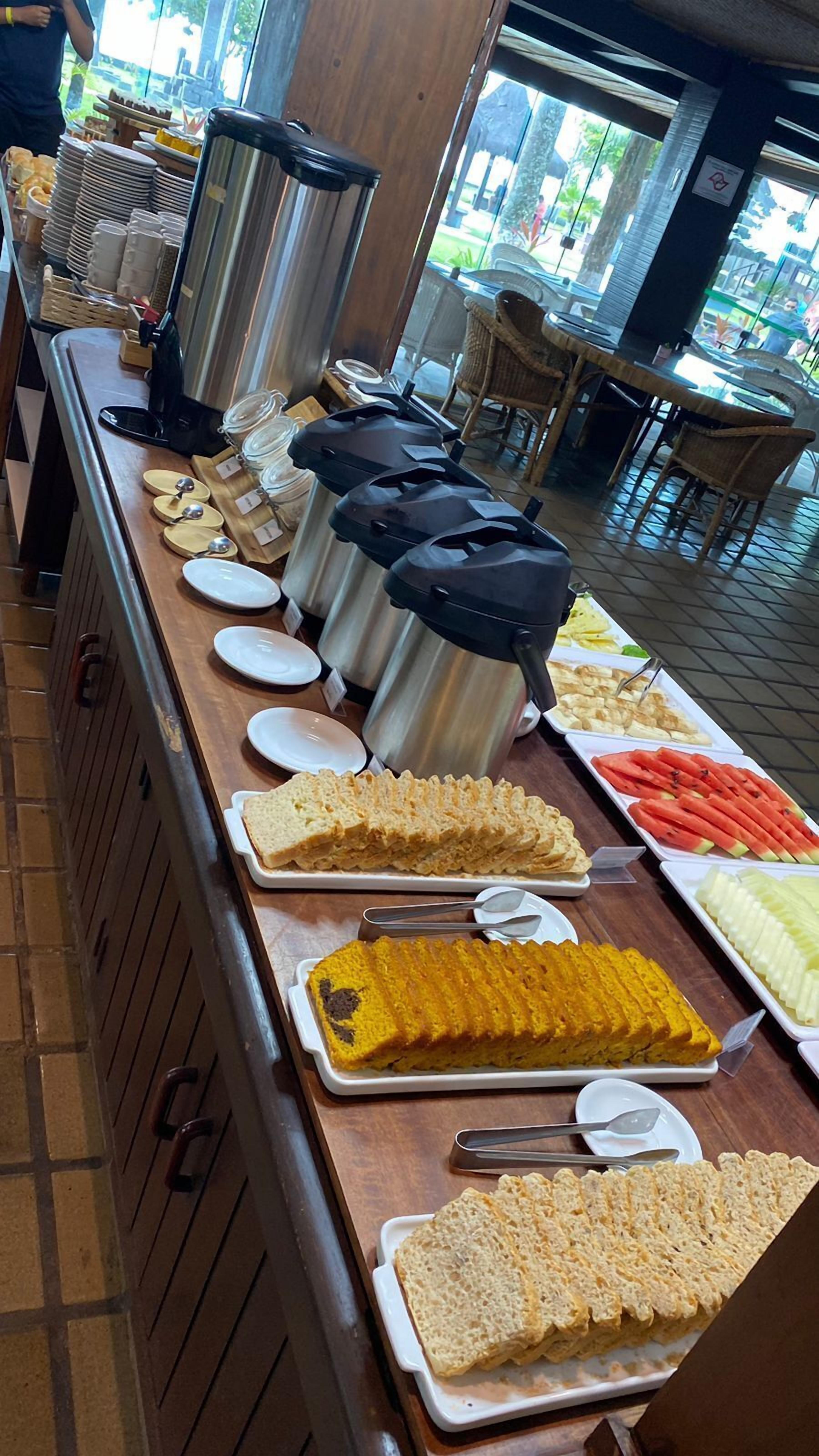 A buffet setup with various food items and serving utensils.