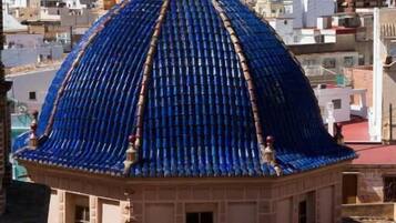 Un edificio con techo abovedado de azulejos azules y estilo arquitectónico tradicional.