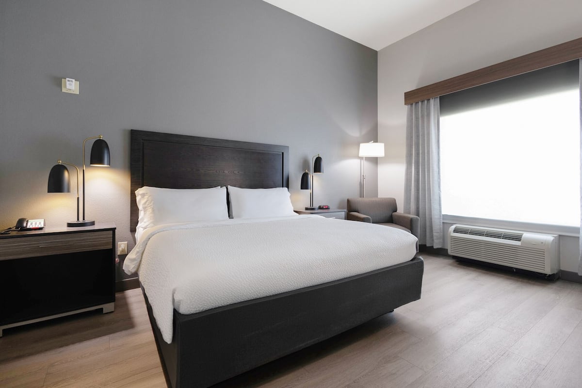 Premium bedding, desk, laptop workspace, blackout drapes