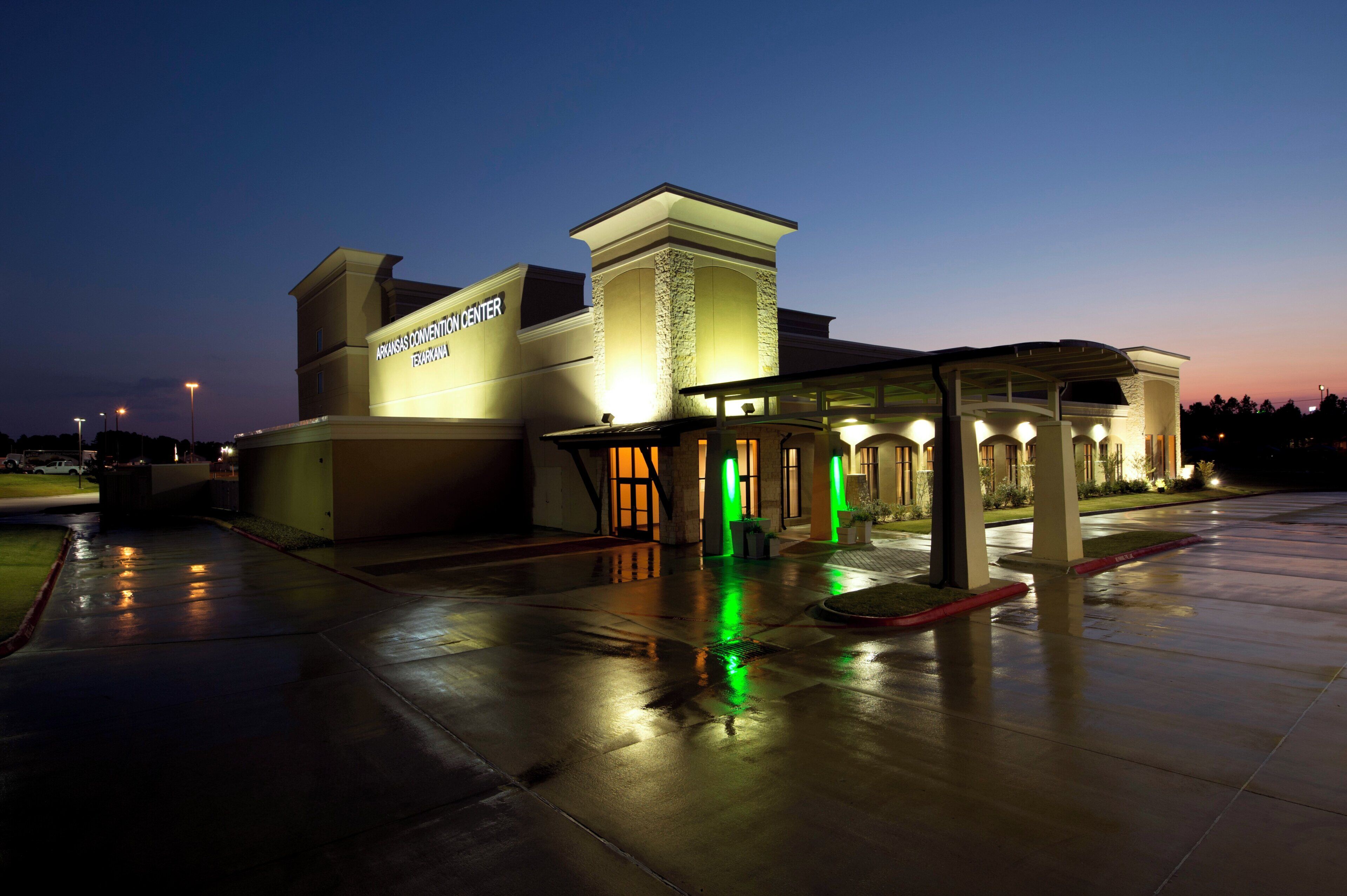 A convention center with a large entrance and a covered waiting area.