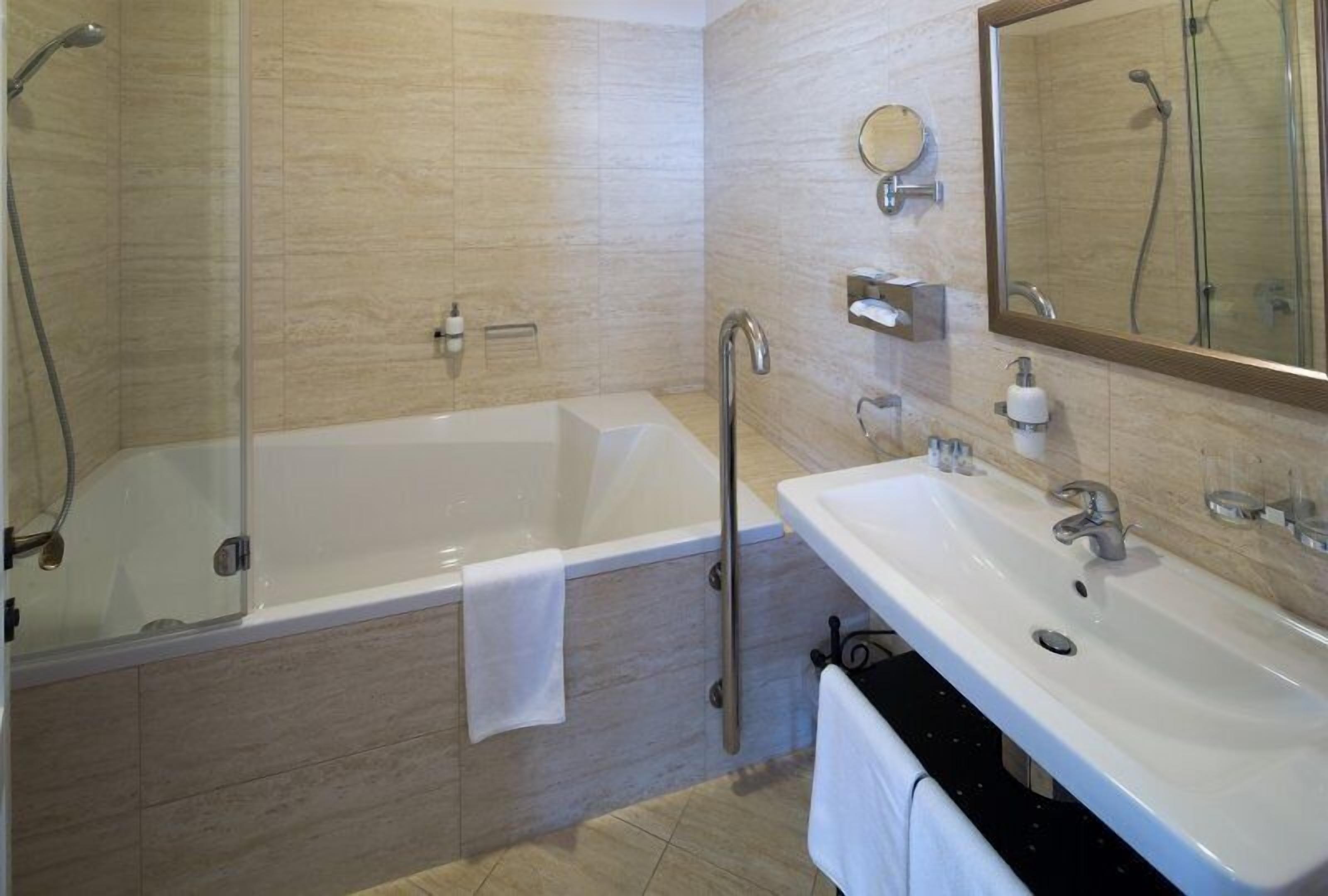 junior suite | bathroom | shower, free toiletries, hair dryer, dressing gowns