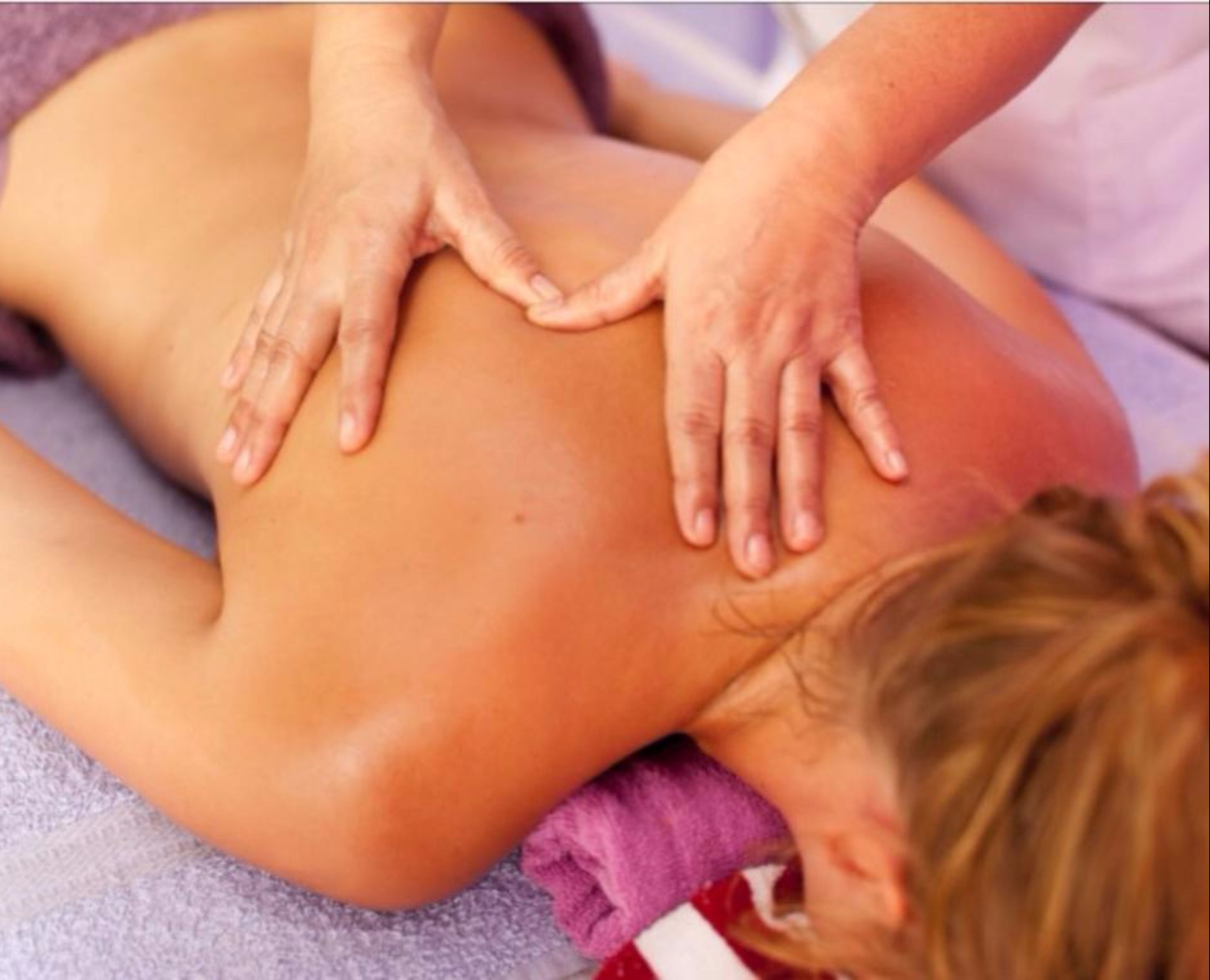 A massage therapy session with a focus on the back and shoulders.