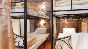 A bunk bed room with metal railings and white bedding. - Gotum Hostel & Restaurant (Phuket)