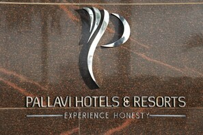 A logo and name of Pallavi Hotels & Resorts with a tagline "Experience Honest". - Pallavi áVIDA (Panvel)