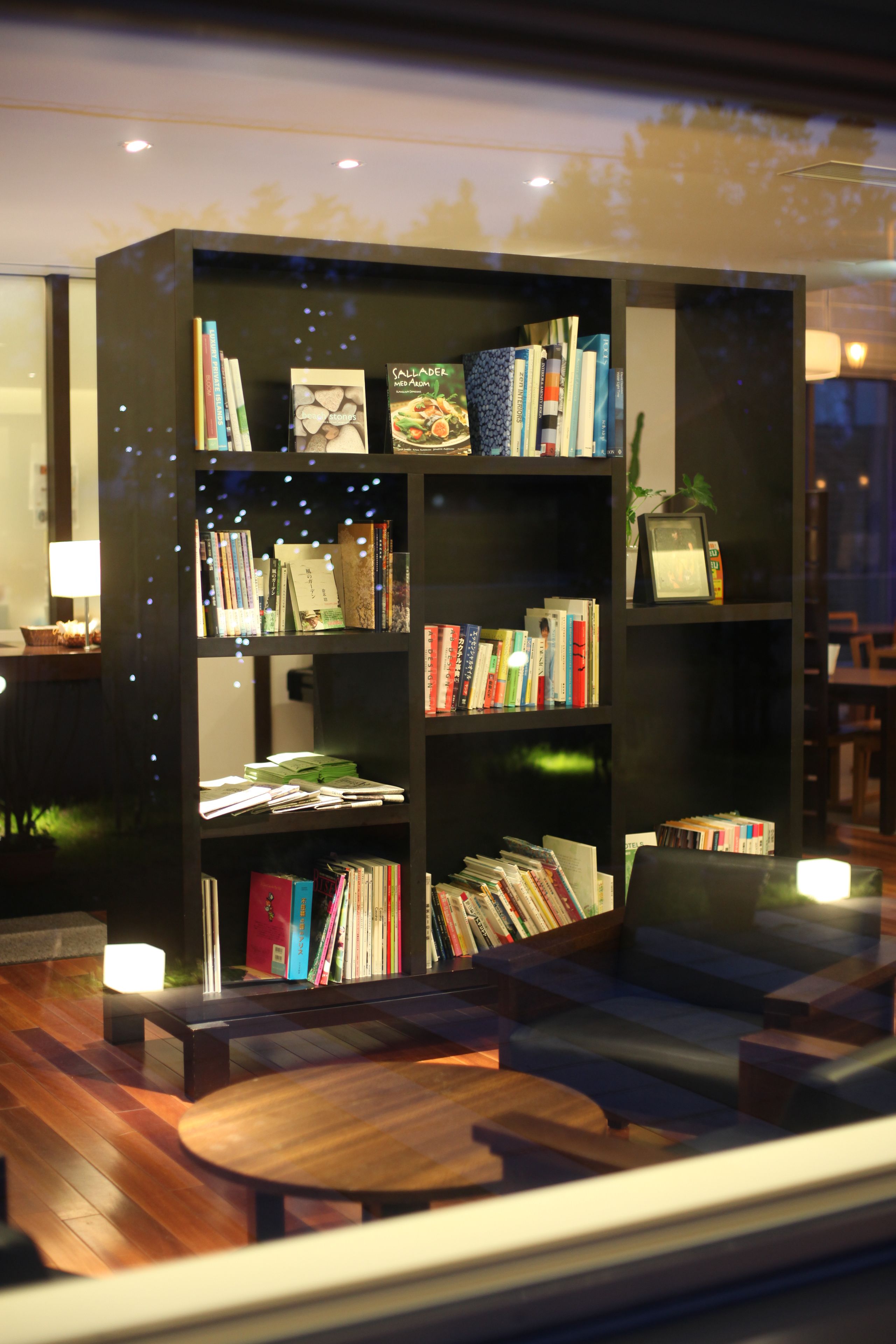 A modern library with bookshelves, a sofa, and a coffee table.