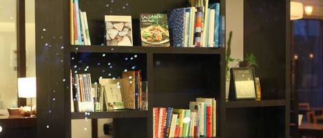 A modern library with bookshelves, a sofa, and a coffee table.