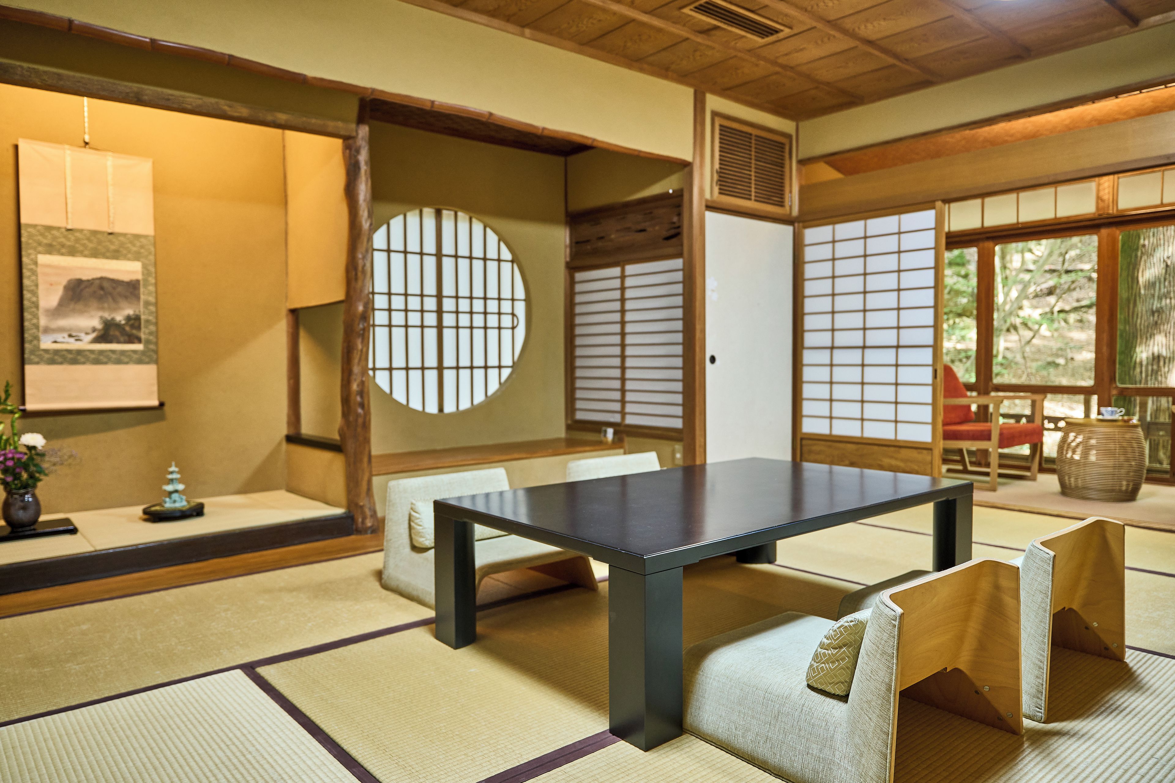A traditional Japanese room with tatami flooring, a low table, and shoji screens.
