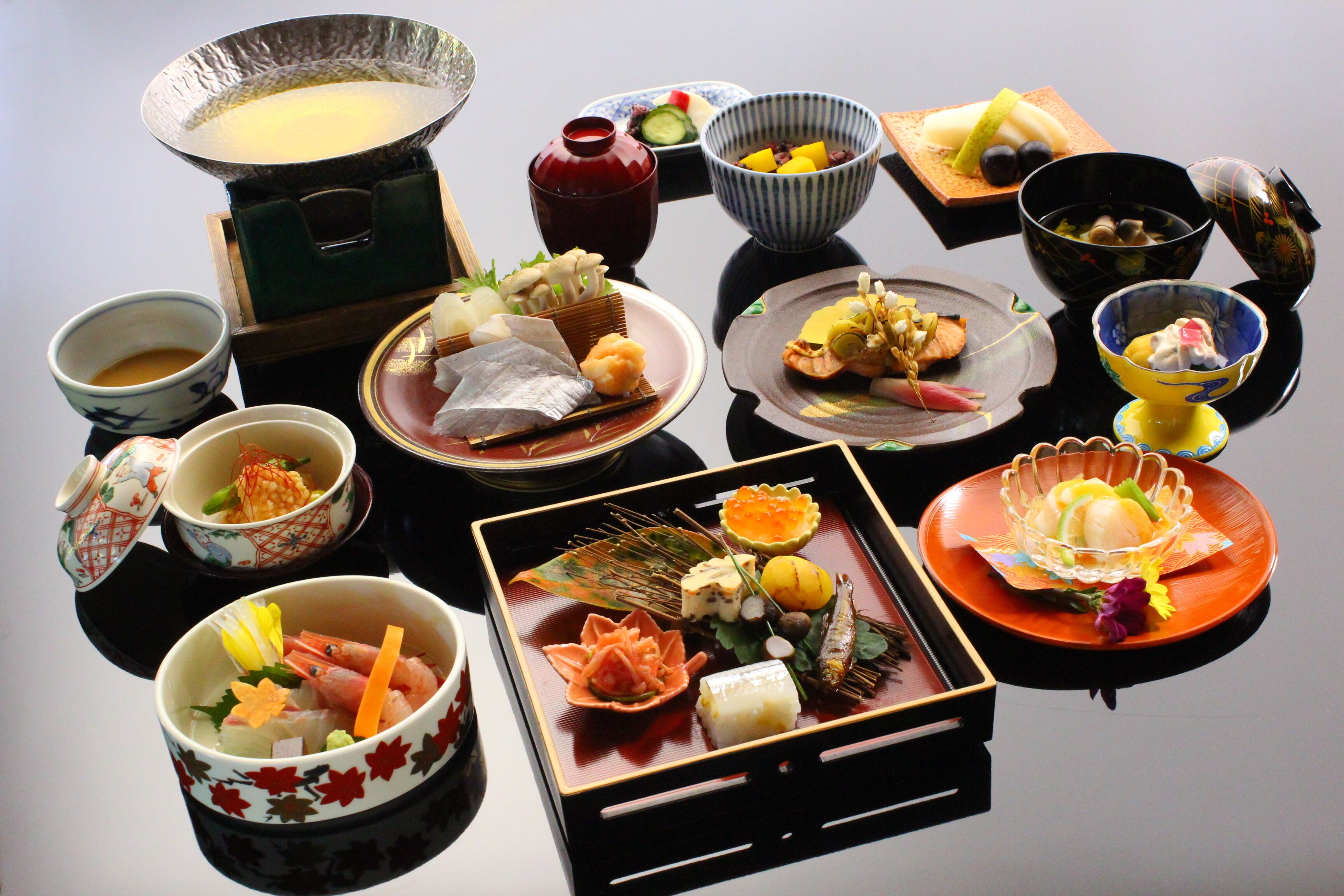 A traditional Japanese meal with various dishes and utensils.