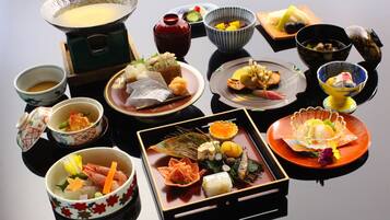 A traditional Japanese meal with various dishes and utensils.