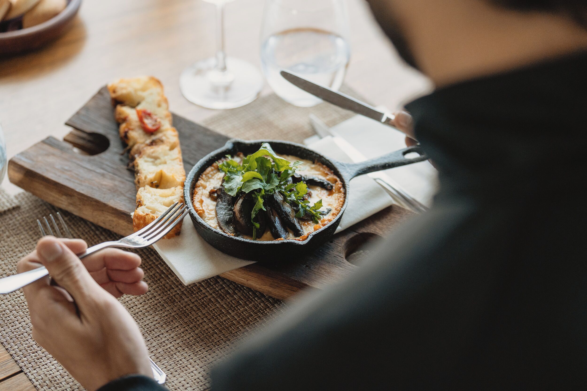 A dining table with a meal, a fork, and a knife.