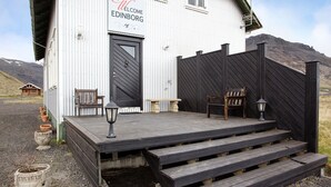 Un edificio blanco con un letrero que dice “Welcome Edinburgh” y una terraza de madera con escalones que llevan a la entrada.