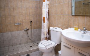 Ein Badezimmer mit Dusche, Toilette und Waschbecken.