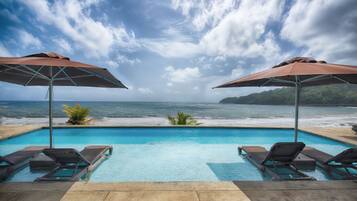 Relax by the pool surrounded by a tranquil sea view.