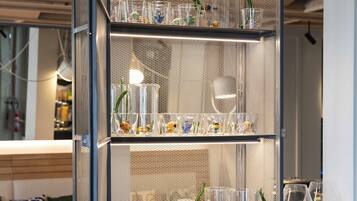 A modern, multi-tiered display case with various glassware and decorative items.