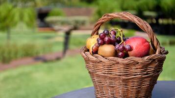 A wicker basket containing fruits on a table.