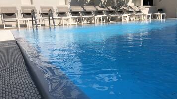 Seasonal outdoor pool, open 9:00 AM to 6:00 PM, pool umbrellas