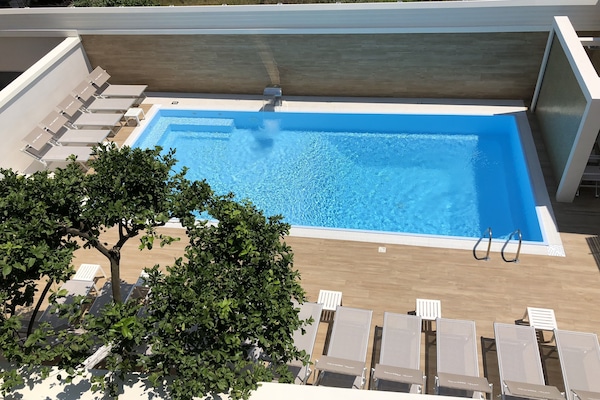 Seasonal outdoor pool, open 9:00 AM to 6:00 PM, pool umbrellas